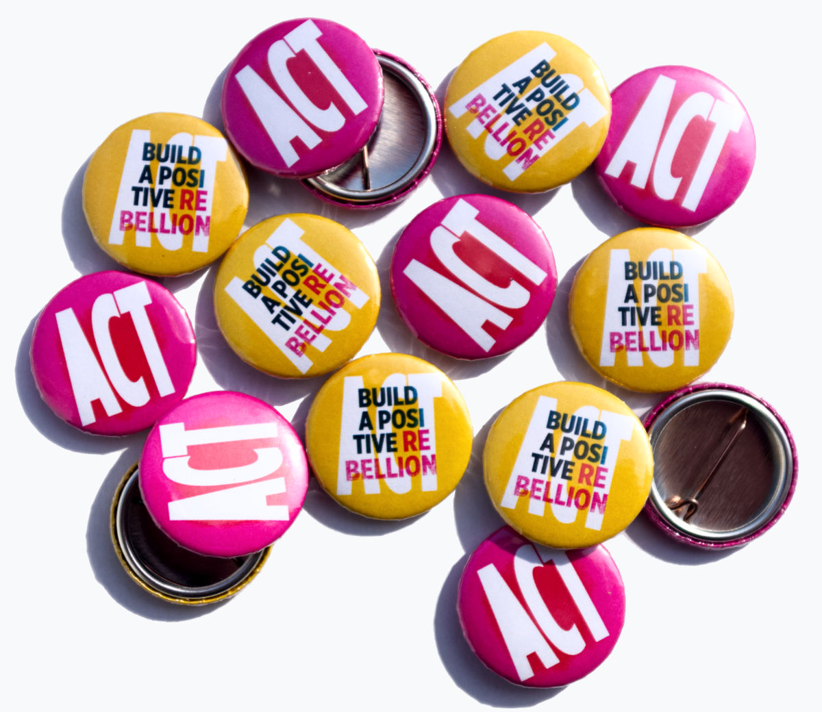 Pins reading 'Build a positive rebellion' and 'Act'